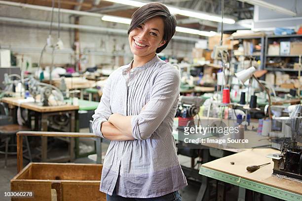 seamstress in clothing factory - garment industry stock pictures, royalty-free photos & images
