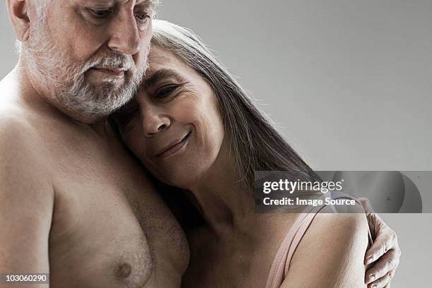 senior couple embracing - female hairy chest stock-fotos und bilder