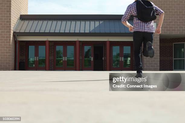 male high school student running toward school - top priority stock pictures, royalty-free photos & images