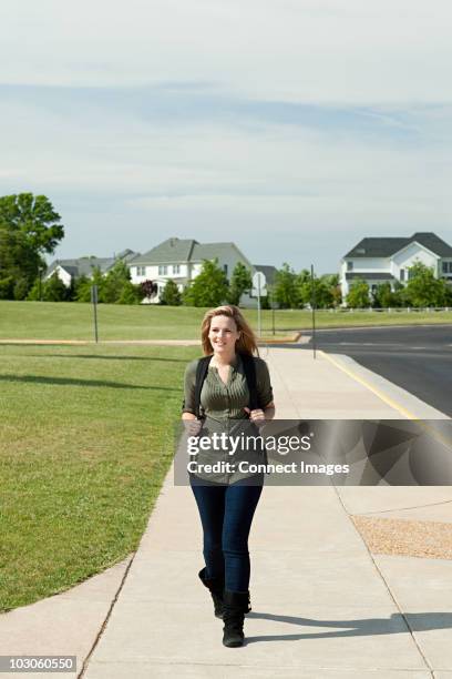 female high school student walking along pavement - haymarket virginia stock pictures, royalty-free photos & images