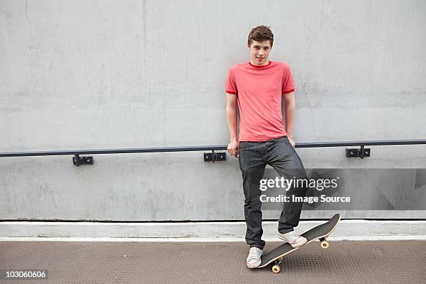 young man with skateboard - boys sport pants stock pictures, royalty-free photos & images