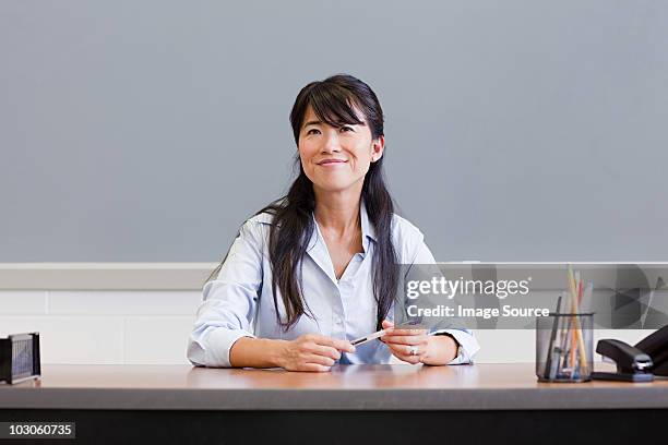 portrait of high school teacher - teacher desk foto e immagini stock