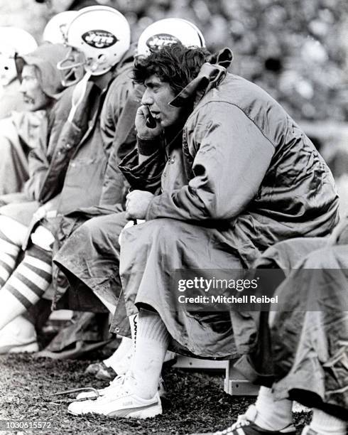 Joe Namath Quarterback for the New York Jets on the bench talking with the offensive coaches getting upstairs. This photo was taken in 1972 at Shea...