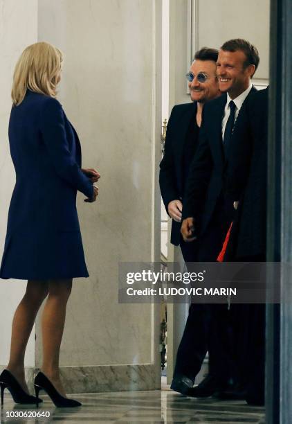 French President Emmanuel Macron and his wife Brigitte Macron speak with Irish lead singer of rock band U2, Paul David Hewson aka Bono, at the Elysee...