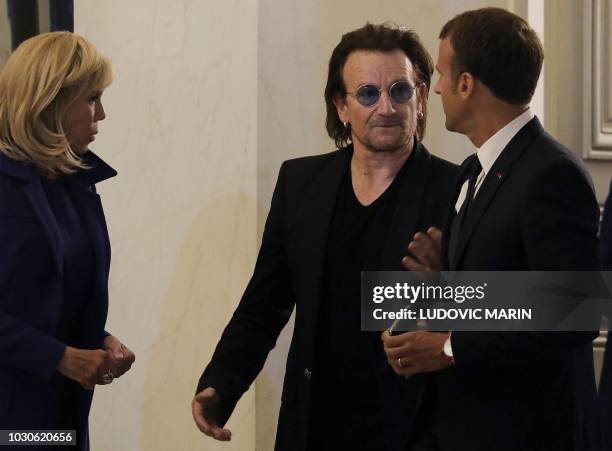 French President Emmanuel Macron and his wife Brigitte Macron speak with Irish lead singer of rock band U2, Paul David Hewson aka Bono, at the Elysee...