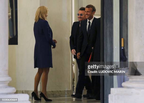 French President Emmanuel Macron and his wife Brigitte Macron speak with Irish lead singer of rock band U2, Paul David Hewson aka Bono, at the Elysee...