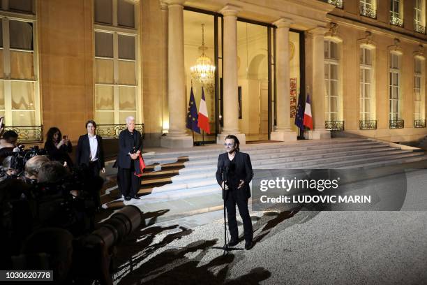 Irish lead singer of rock band U2, Paul David Hewson aka Bono delivers a statement in the courtyard of the Elysee Palace, in Paris, after a meeting...