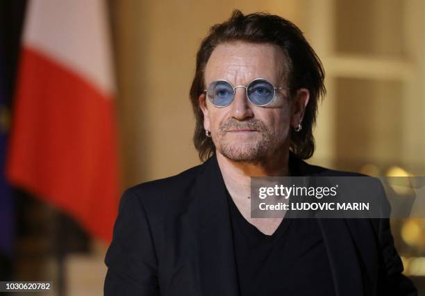 Irish lead singer of rock band U2, Paul David Hewson aka Bono delivers a statement in the courtyard of the Elysee Palace, in Paris, after a meeting...