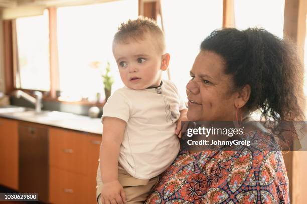 grandmother holding young grandson - australasia stock pictures, royalty-free photos & images