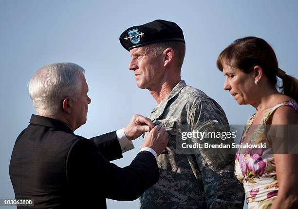 Annie McChrystal stands with her husband Gen. Stanley McChrystal as he is awarded the Department of Defense Distinguished Service Medal by Secretary...