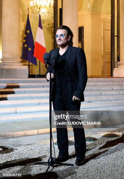 Irish lead singer of rock band U2, Paul David Hewson aka Bono delivers a statement in the courtyard of the Elysee Palace, in Paris, after a meeting...