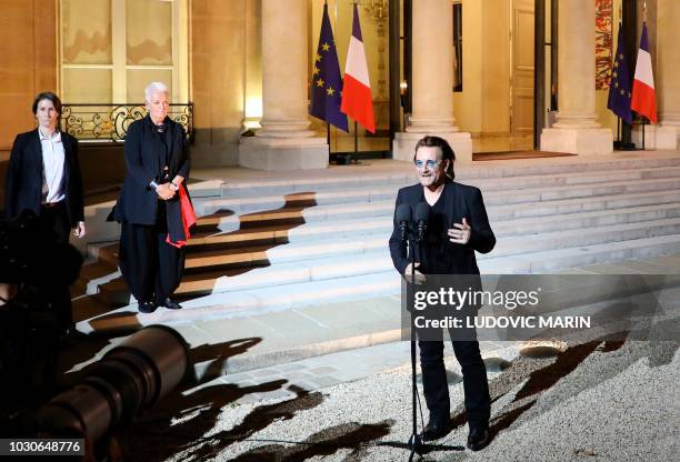 Irish lead singer of rock band U2, Paul David Hewson aka Bono delivers a statement in the courtyard of the Elysee Palace, in Paris, after a meeting...