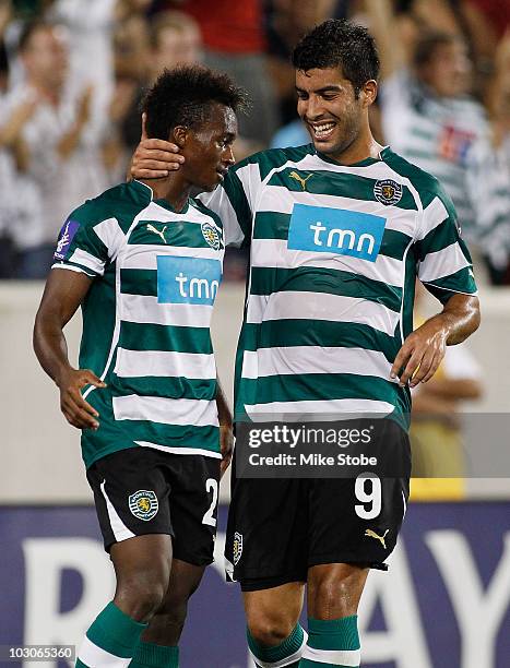 Yannick Djalo of Sporting Lisbon celebrates his goal in the 23rd minute with teammate Carlos Saleiro against Manchester City in the Barclays New York...