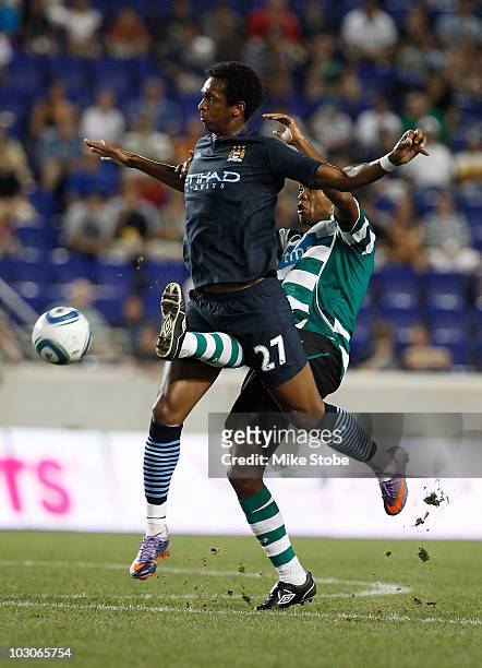 Evaldo Fabiano of Sporting Lisbon battles for the ball against Jo Silva of Manchester City on July 23, 2010 at Red Bull Arena in Harrison, New...
