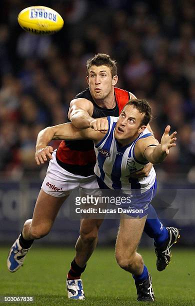 David Hale of the Kangaroos and Cale Hooker of the Bombers contests for a mark during the round 17 AFL match between the North Melbourne Kangaroos...