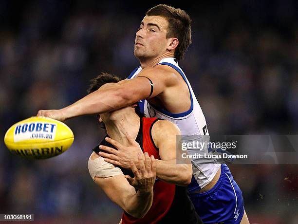 Ben Cunnington of the Kangaroos and Angus Monfries of the Bombers contests for a mark during the round 17 AFL match between the North Melbourne...