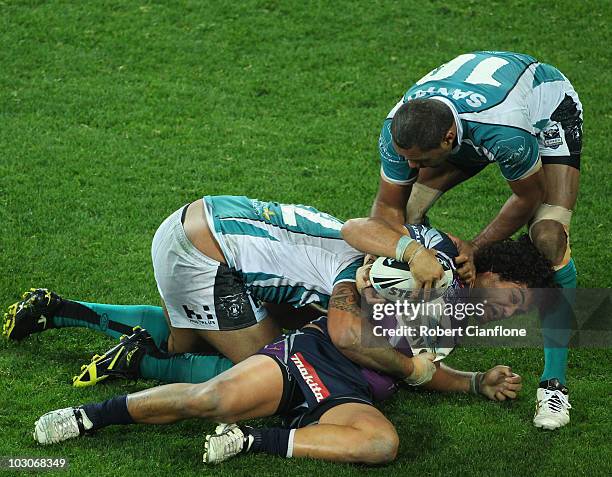 Adam Blair of the Storm is held down by his opponents during the round 20 NRL match between the Melbourne Storm and the Penrith Panthers at AAMI Park...