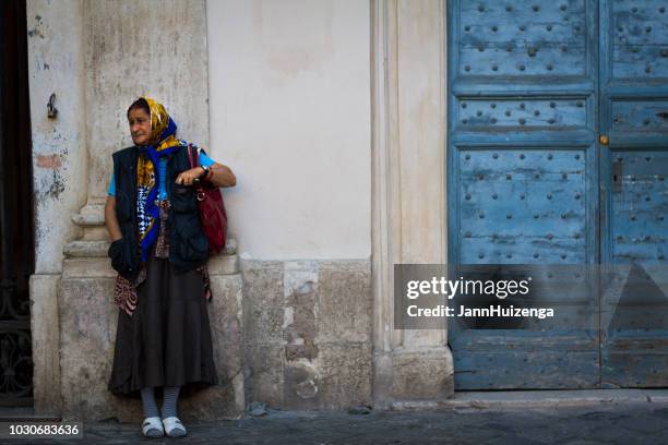 rome, italy: woman begging at church in trastevere - gypsy stock pictures, royalty-free photos & images