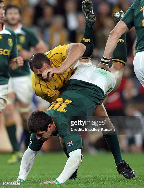 Quade Cooper of the Wallabies lifts Morne Steyn of the Springboks in the tackle during the 2010 Tri-Nations match between the Australian Wallabies...