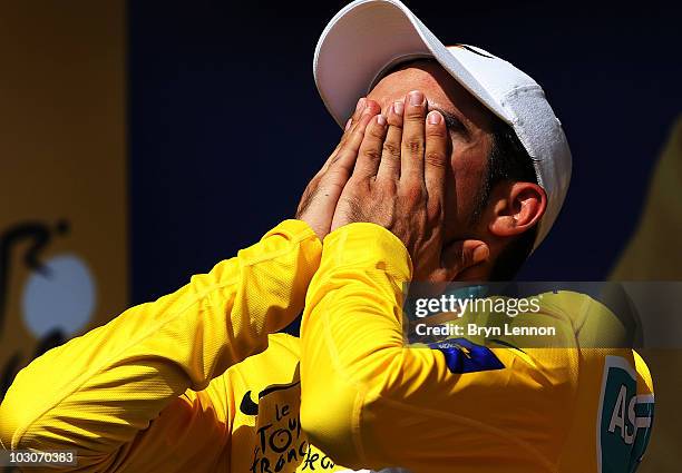 Alberto Contador of Spain and the Astana Team reacts on the podium after retaining his yellow jersey on stage nineteen, a 52km individual time trial...