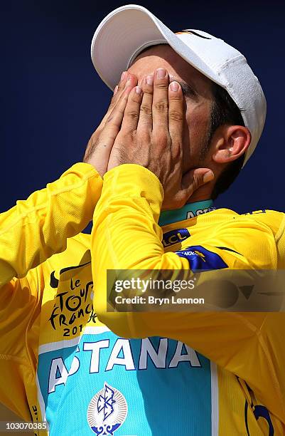 Alberto Contador of Spain and the Astana Team reacts on the podium after retaining his yellow jersey on stage nineteen, a 52km individual time trial...