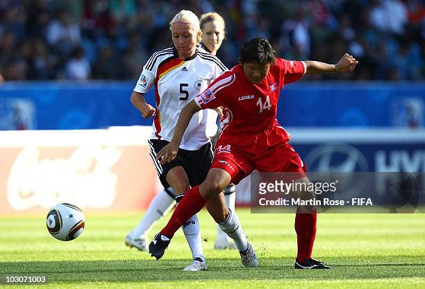 Kristina Gessat of Germany and Hyon Hi Yun of North Korea compete for the ball during the FIFA U20 Women's World Cup Quarter Final match between...