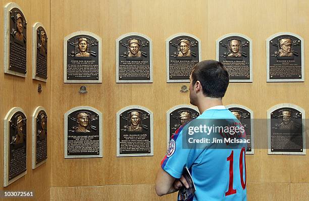 Fan of 2010 inductee Andre Dawson views the plaques of inducted members at the Baseball Hall of Fame and Museum during induction weekend on July 24,...