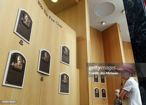 Young baseball fans views the plaques of inducted members at the Baseball Hall of Fame and Museum during induction weekend on July 24, 2010 in...