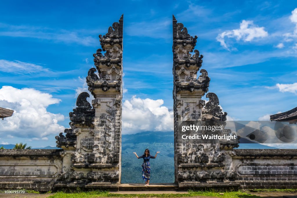 Young woman standing at Gate to heaven,Pura Lempuyang temple,Bali,Indonesia