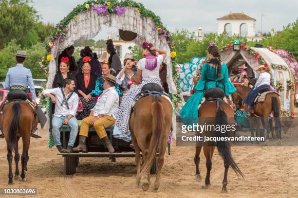 group of pilgrims in a cart during the romeria del rocio, el rocio, spain. - el rocio stock pictures, royalty-free photos & images