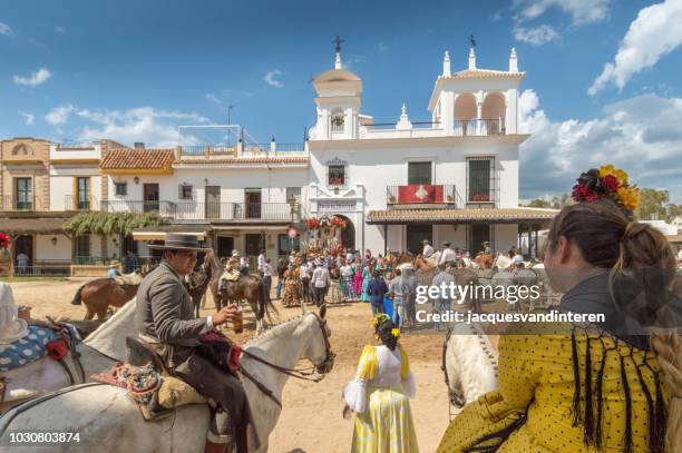 group of pilgrims arriving in el rocio, spain, during the romeria del rocio. - el rocio stock pictures, royalty-free photos & images