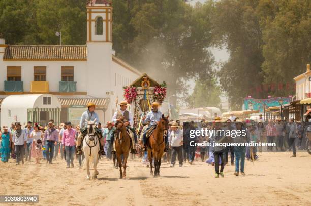 group of pilgrims arriving in el rocio, spain, during the romeria del rocio. - el rocio stock pictures, royalty-free photos & images