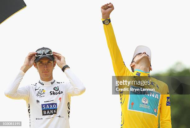 Andy Schleck of team Saxo Bank, who finished 2nd overall, looks on as Alberto Contador of team Astana celebrates on the podium after the twentieth...