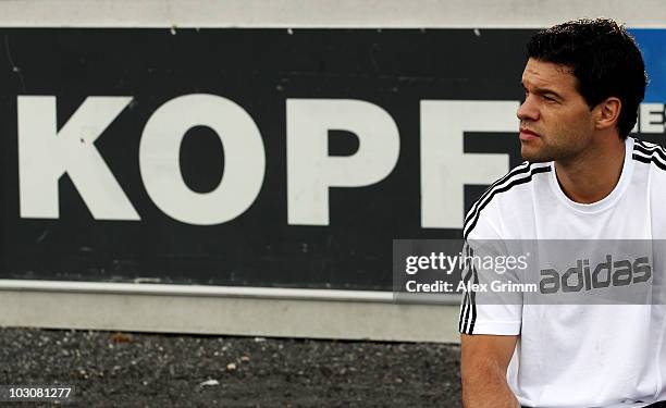 Michael Ballack watches team mates warm up before the pre-season friendly match between SCR Altach and Bayer 04 Leverkusen on July 25, 2010 in...