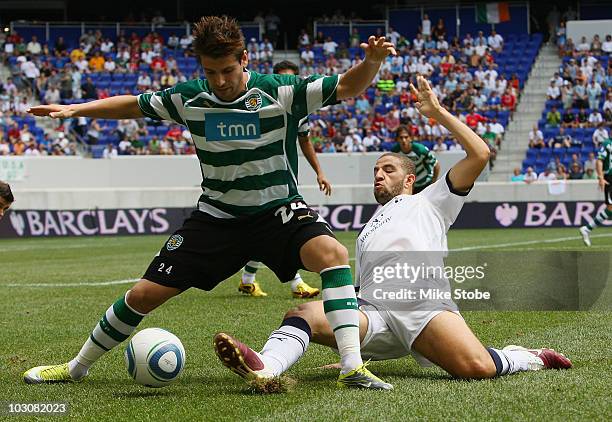 Adel Taarabt of Tottenham Hotspur attempts to steal the ball from Miguel Veloso of Sporting Lisbon on July 25, 2010 at Red Bull Arena in Harrison,...