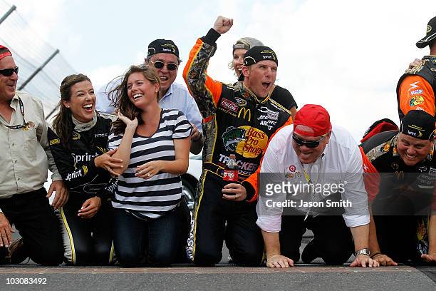 Jamie McMurray, driver of the Bass Pro Shops/Tracker Boats Chevrolet, celebrates by kissing the bricks with wife Christy McMurray, co-owner Felix...