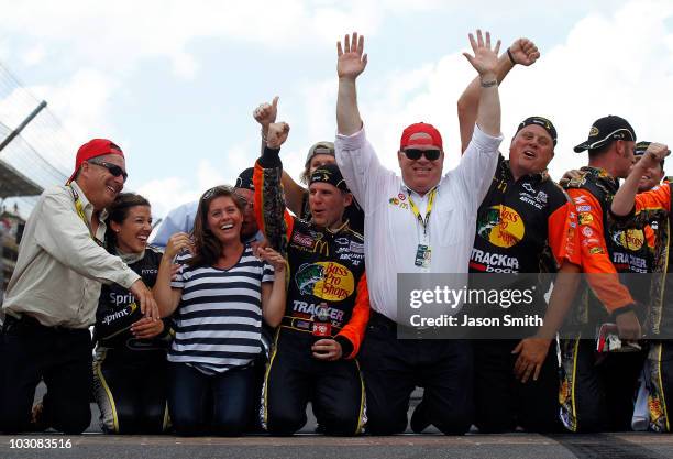 Jamie McMurray, driver of the Bass Pro Shops/Tracker Boats Chevrolet, celebrates by kissing the bricks with wife Christy McMurray, co-owner Felix...