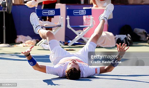 Mardy Fish falls to the court celebrating his win over John Isner in the finals of the Atlanta Tennis Championships at the Atlanta Athletic Club on...