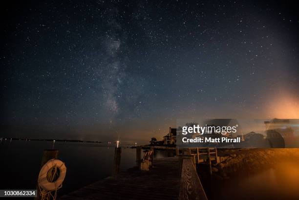 the milky way over a new england dock and beach houses - connecticut landscape stock pictures, royalty-free photos & images