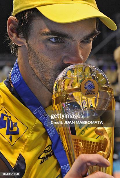 Brazil's captain Giba kisses the trophy during celebrations after the World League 2010 final against Russia at Orfeo Superdomo stadium in Cordoba on...