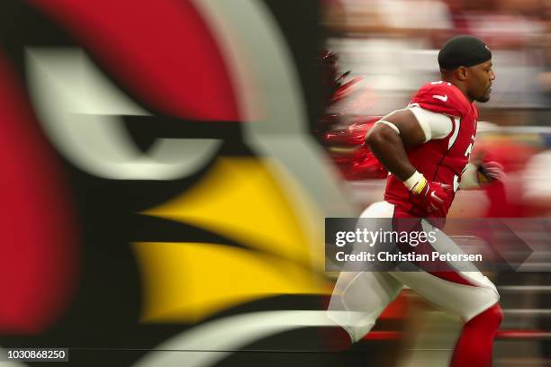 Running back David Johnson of the Arizona Cardinals runs onto the field during introductions to the NFL game against the Washington Redskins at State...