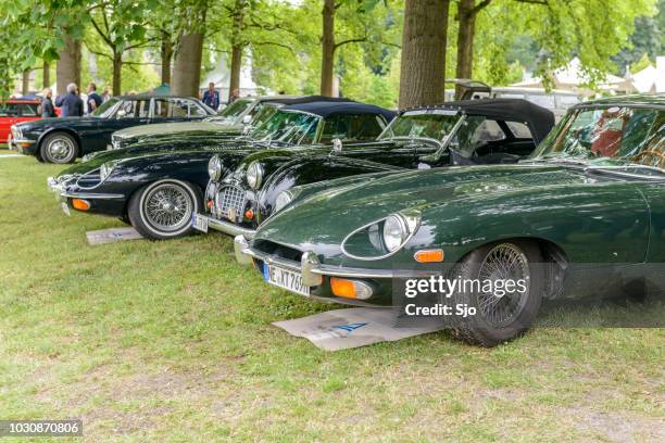 jaguar e-type coupe and convertible flanking a jaguar xk120 roadster classic british sports car - expo 2017 stock pictures, royalty-free photos & images