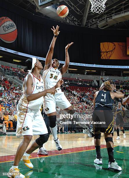 Le'Coe Willingham of the Seattle Storm goes to the basket against Amber Holt of the Tulsa Shock on July 25, 2010 at Key Arena in Seattle, Washington....