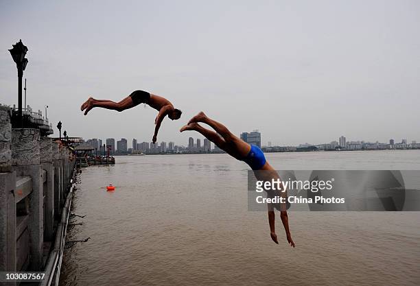 Swimmers dive into water area where the Yangtze River and Hanjiang River converge on July 25, 2010 in Wuhan of Hubei Province, central China. The...