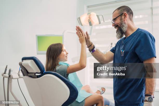 pediatric dentistry. job well done! - orthodontist stock pictures, royalty-free photos & images