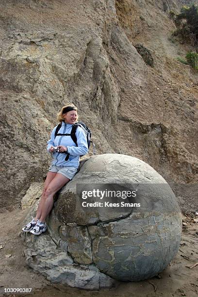 Woman Leaning On Rock Photos and Premium High Res Pictures - Getty Images