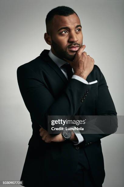 the brains behind his business - hand on chin stock pictures, royalty-free photos & images