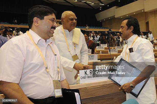 Deputy Chief Minister of Tamil Nadu M K Stalin shakes hands with Karnataka Chief Minister B S Yeddyurappa as Textiles Minister Dayanidhi Maran looks...
