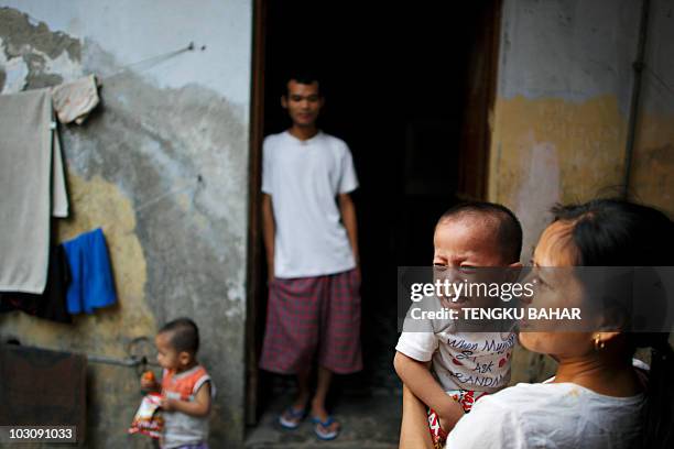 In this June 25, 2009 photograph, an ethnic Chin refugee child from Myanmar cries as several refugees gather in an alley by their living quarters in...