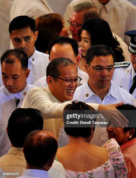 President Of The Philippines Benigno "NoyNoy" Aquino shakes wellwishers' hands as he delivers his first State Of The Nation Address following his...